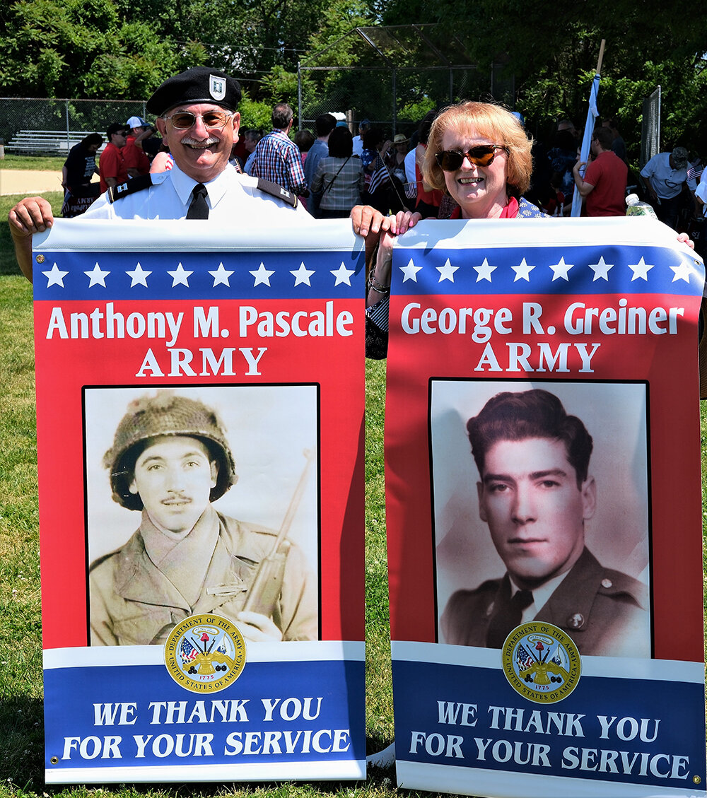 Dr. Anthony Pascale and his wife Sandy hold their Hometown Hero banners with pictures of their fathers.